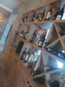 a wooden cabinet filled with lots of bottles of wine at Randevu in Caracal