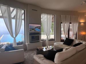 ein Wohnzimmer mit 2 Sofas und großen Fenstern in der Unterkunft Matteo Villa Limassol Cyprus in Limassol