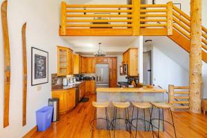 a kitchen with wooden cabinets and a loft bed at Mountain View Cabin - Hot Tub - Sleeps 14 - 4 Bedrooms in Park City