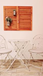 two chairs and a glass table in front of a window at Il Mare Di Roma in Lido di Ostia