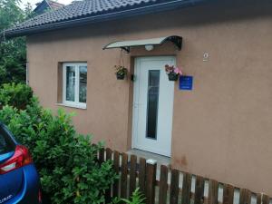 a house with a white door and a fence at City Break Apartment in Zagreb +3 photos