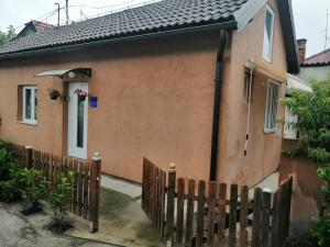 a house with a wooden fence in front of it at City Break Apartment in Zagreb