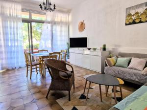 a living room with a couch and a table at Banyuls-sur-Mer, T3, Rez-de-chaussée avec terrasse, parking, proche Thalassothérapie - FR-1-309-295 in Banyuls-sur-Mer
