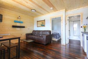 a living room with a leather couch and a table at The Valley View in Creston