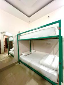two bunk beds in a room with a mirror at Shanti Hostel Rishikesh in Rishīkesh