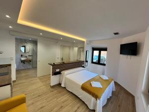 a hotel room with a large bed and a bathroom at Marusía in Muxia