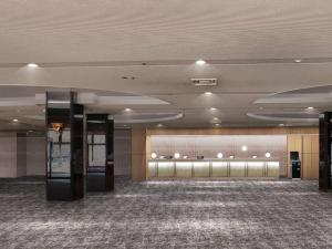 a lobby with a large room with a large carpet at Mercure Urabandai Resort & Spa in Kitashiobara