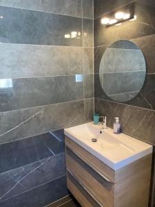 a bathroom with a sink and a mirror at Maxima Sunset in Sainte-Maxime