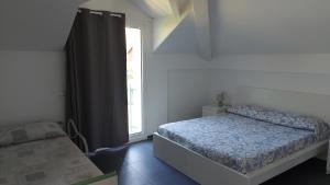 Un pat sau paturi într-o cameră la B&B La casa al mare di MatiGiò "Camera M"