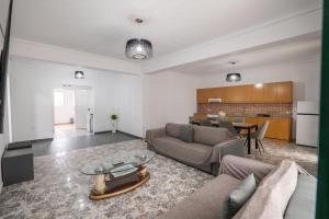 a living room with a couch and a table at Hoteleks Inn & Suites in Sarandë