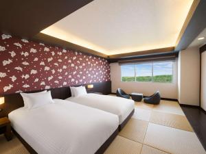 เตียงในห้องที่ Grand Mercure Okinawa Cape Zanpa Resort