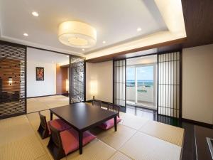 a dining room with a table and chairs at Grand Mercure Okinawa Cape Zanpa Resort in Yomitan