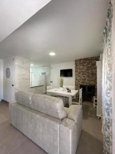 a living room with a couch and a table at Casa Javi y Carmen in Coto Rios