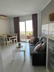 a living room with a couch and a table at Apartamento Duquesa de España Torremolinos in Torremolinos