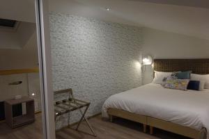 Habitación de hotel con cama y espejo en Apparts Watteau, en Limoges