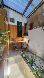 a patio with a table and chairs and plants at Airam in Cefalù