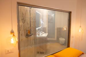 a bathroom with a shower with a sink and a toilet at Airam in Cefalù