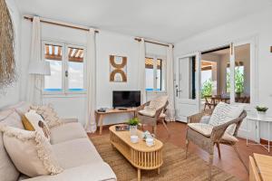 a living room with a couch and chairs and a table at Mon Palau in Sant Lluis