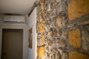 a stone wall in a room with a door at Airam in Cefalù
