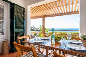a dining room with a table with a view of the ocean at Mon Palau in Sant Lluis