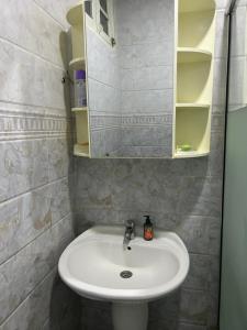 a bathroom with a sink and a mirror at Yassine's home in Jijel