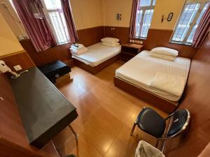 A bed or beds in a room at New Garden Hostel