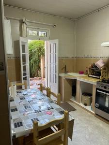 a kitchen with a table in the middle of it at Yassine's home in Jijel