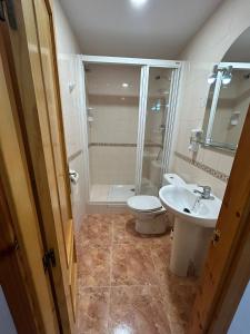 a bathroom with a toilet and a sink and a shower at Pensión Arnedo in Arnedo