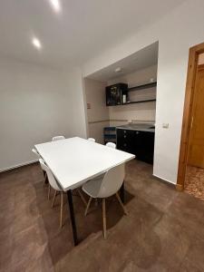 a white table and chairs in a room at Pensión Arnedo in Arnedo