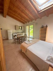 a bedroom with a large bed and a kitchen at Agape in Caprino Veronese