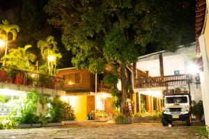 a truck parked in front of a building at night at Hotel Camoruco in Yopal