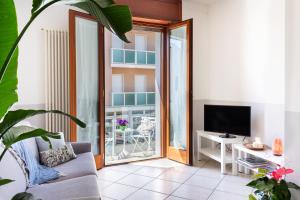 a living room with a couch and a television at CASA GABRIELLA in Cattolica
