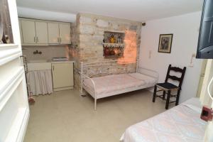 a small room with a bunk bed and a kitchen at Junior paradise! in Agiassos