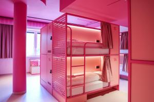 a pink room with bunk beds in it at Bunks at Rode in Oslo
