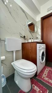 a bathroom with a toilet and a washing machine at La pigna delle Aci Apartment in Acireale