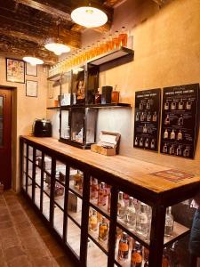 a bar in a restaurant with a counter with bottles at Original Trebic whisky bar Room in Třebíč +39 photos