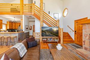 a living room with a couch and a large television at Mountain View Cabin - Hot Tub - Sleeps 14 - 4 Bedrooms in Park City