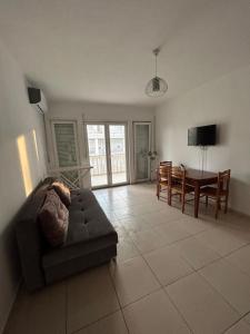 a living room with a couch and a table at Grand Hotel Europa Resort Velipoje Apartment in Velipojë