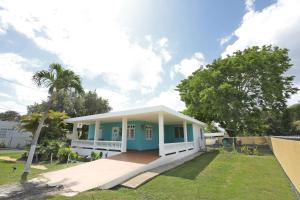 una casa azul y blanco en Casa Lula Beach Retreat - Fenced backyard, en Arecibo