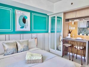 a living room with a bed and a kitchen at Casa Verde Studio at Azure North by THE BALI CORNER AT AZURE NORTH, Stylish, Spacious Balcony with Beautiful View of Mt Arayat in San Fernando