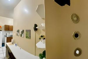 a bathroom with a white counter and a sink at Umbelino Moradia in Santarém +37 photos