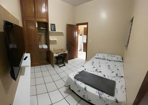 a bedroom with a bed and a tiled floor at Umbelino Moradia in Santarém