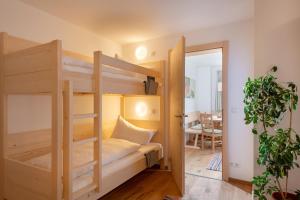 a room with two bunk beds and a table at Appartement Naturbunt in Söll