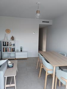 a living room with a wooden table and chairs at Beach,s House in Playa del Puig in La Torre +11 photos