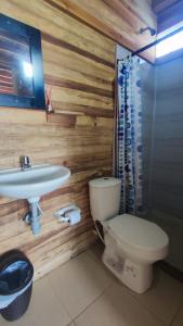a bathroom with a toilet and a sink at Zakua Beach in Guachaca