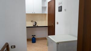 a small kitchen with a washer and dryer at Villa ReyAn Durrës in Durrës
