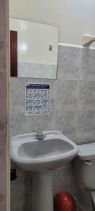 a bathroom with a sink and a toilet at Hotel Colonial El Bosque in Tunja