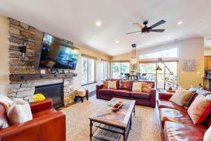 a living room with couches and a fireplace at Pooewin Place in South Lake Tahoe
