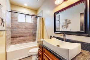 a bathroom with a sink and a tub and a toilet at Pooewin Place in South Lake Tahoe +14 photos