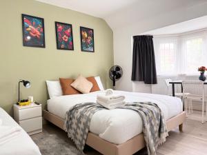 a bedroom with a bed and a table with a chair at Charming Studio 30min to Central London in London